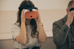Meitene, kurai uz sejas ir virtuālās realitātes brilles.